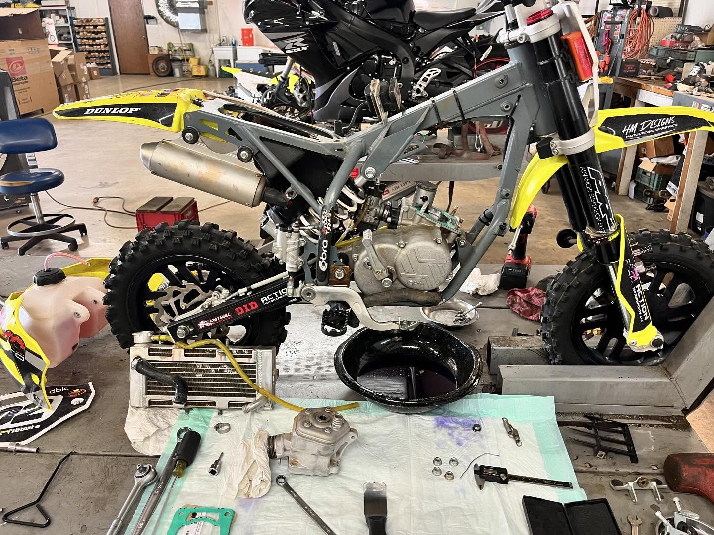 Dirt bike engine and chassis during a shop rebuild