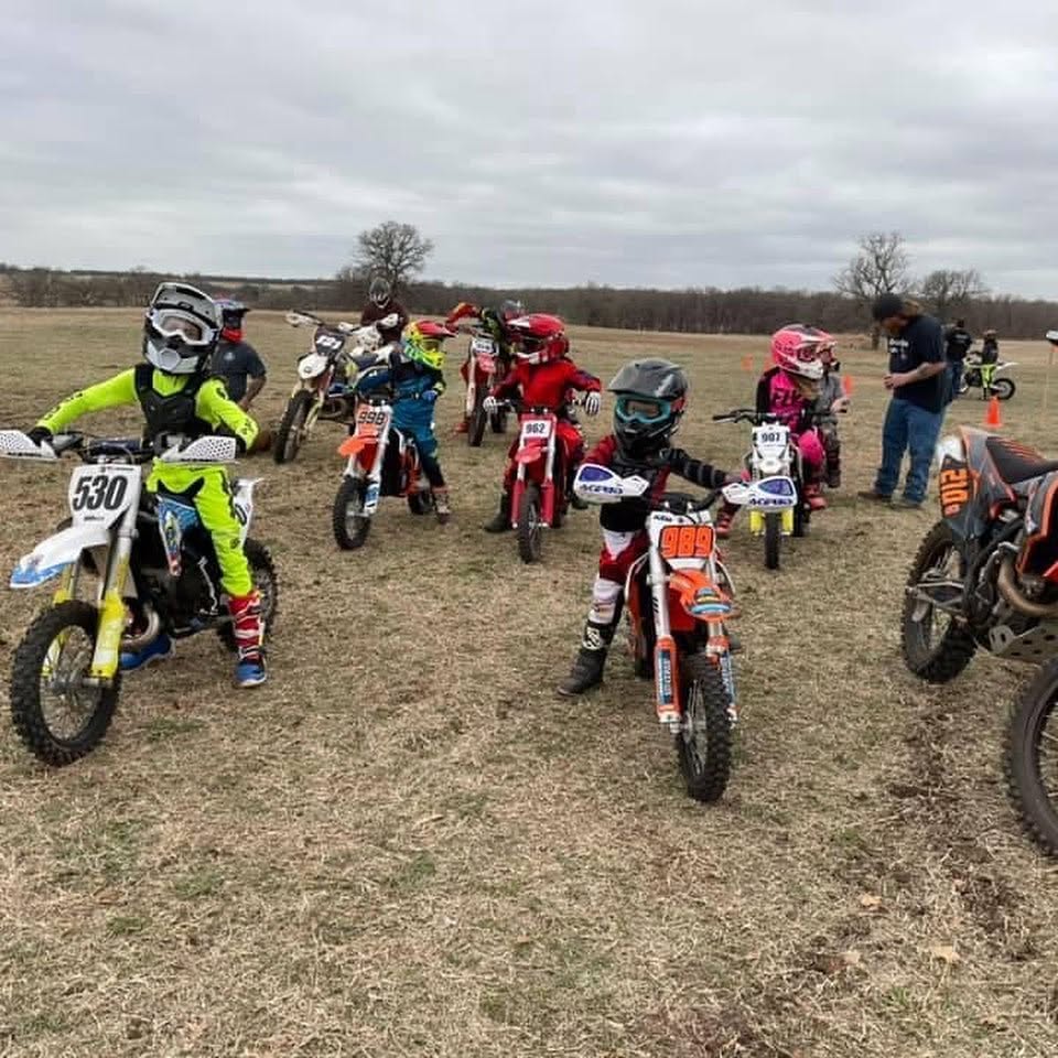 Youth dirt bike riders lined up before a race